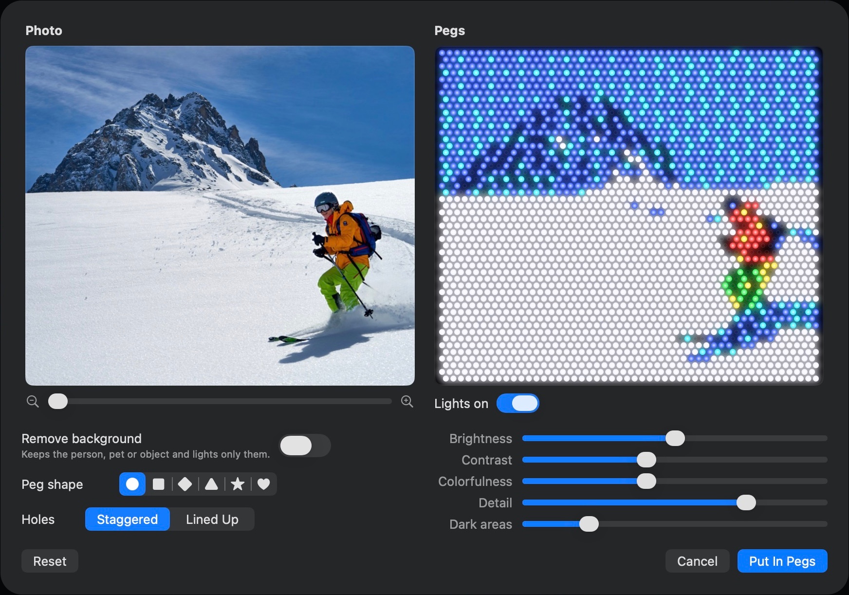 The Photo to Pegs window: a photo of a skier below a snowy peak, beside the same scene in glowing blue, white, red, yellow and green pegs, with sliders for brightness, contrast, colorfulness, detail and dark areas.